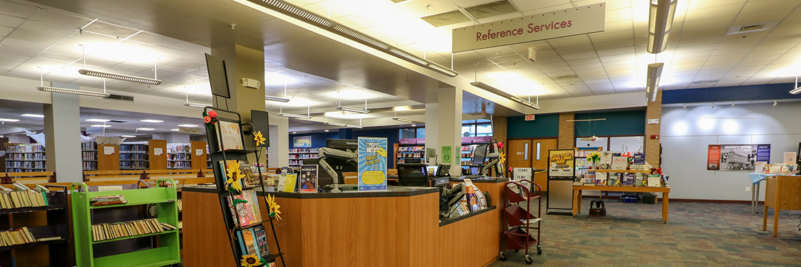 Adult Services Desk underneath a Reference Services sign